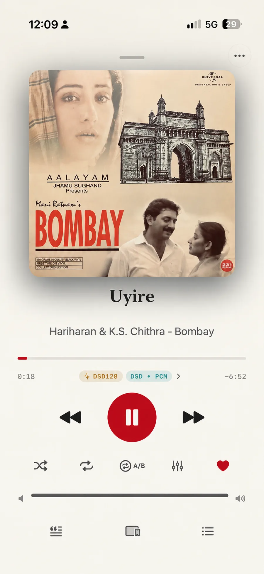 Isai playing Uyire from Bombay, by Hariharan and K.S. Chithra: the sleeve above the title, a progress bar at 0:18 with 6 minutes 52 left, and two chips beneath it reading DSD128 and DSD to PCM, with a chevron that opens the Signal Path. Shuffle, repeat, A/B, equalizer and favourite sit under the transport controls.