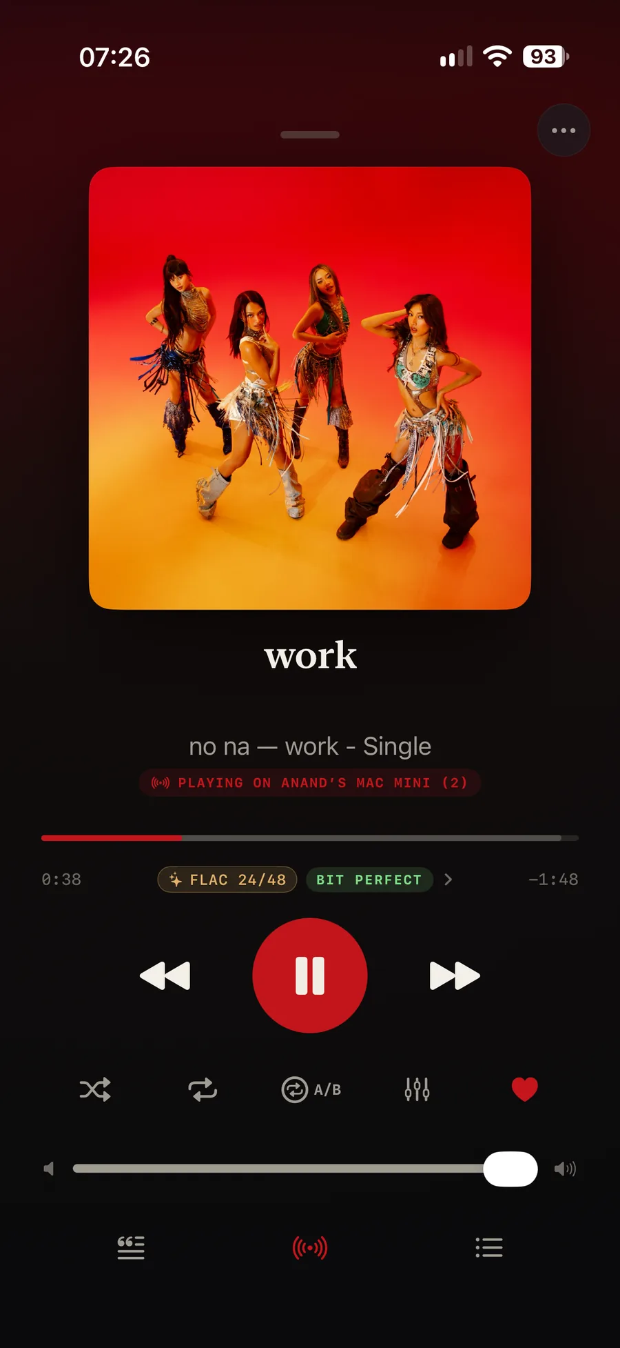 Isai on an iPhone driving another machine: under the track work by no na, a red banner reads PLAYING ON ANAND&rsquo;S MAC MINI, with chips below it reading FLAC 24/48 and BIT PERFECT, and the Play On icon lit red in the toolbar at the foot of the screen.
